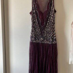 Beautiful net fancy dress in plum color with sequins work and sexy mesh fabric